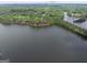 Aerial shot showcasing lakeside property surrounded by dense trees, offering seclusion at 504 Telfair Park, Peachtree City, GA 30269