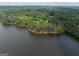 Beautiful aerial view of a lakeside home surrounded by mature trees at 504 Telfair Pk at 504 Telfair Park, Peachtree City, GA 30269