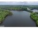 Serene aerial view showcasing the home's stunning lakefront location and lush surroundings at 504 Telfair Pk at 504 Telfair Park, Peachtree City, GA 30269