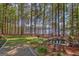 Scenic backyard with mature trees, pond, and lake access, offering a tranquil retreat at 504 Telfair Park, Peachtree City, GA 30269