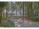 Picturesque stone pathway leading through a wooded area to a serene lakefront view at 504 Telfair Park, Peachtree City, GA 30269