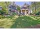 Exterior home view from the backyard showcasing a patio, stairs, and well manicured lawn at 504 Telfair Park, Peachtree City, GA 30269