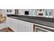 Close up of the bar with white cabinets and dark stone countertop with beverage refrigerator at 504 Telfair Park, Peachtree City, GA 30269