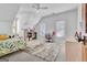 Bright bedroom with a ceiling fan, desk, white walls, and a soft rug at 504 Telfair Park, Peachtree City, GA 30269