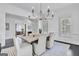 Bright dining room with modern chandelier, gray table with seating for six and plenty of natural light at 504 Telfair Park, Peachtree City, GA 30269