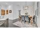 Stylish dining room features decorative wallpaper, modern lighting, and seating for six at 504 Telfair Park, Peachtree City, GA 30269
