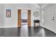 Bright foyer featuring decorative mirror, a decorative console table and view through wood sliding doors into a living room at 504 Telfair Park, Peachtree City, GA 30269