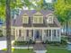 Inviting home boasts a classic facade, a covered front porch, and a convenient three-car garage at 504 Telfair Park, Peachtree City, GA 30269