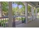 Spacious front porch with a classic railing and columns and a view of the lush green neighborhood landscape at 504 Telfair Park, Peachtree City, GA 30269