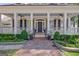Inviting front porch with classic columns, black shutters, a brick walkway, and tasteful landscaping at 504 Telfair Park, Peachtree City, GA 30269