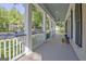 Relaxing front porch with white railings and columns, and a serene view of the neighborhood street at 504 Telfair Park, Peachtree City, GA 30269