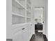 Hallway featuring built-in shelving with cabinets and a view through an open doorway into a living room at 504 Telfair Park, Peachtree City, GA 30269