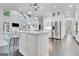 Open-concept kitchen features a large center island, stainless steel appliances, and custom cabinetry at 504 Telfair Park, Peachtree City, GA 30269