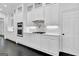 Modern kitchen boasts white cabinets, stainless steel appliances and sleek countertops at 504 Telfair Park, Peachtree City, GA 30269