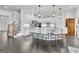 Modern white kitchen with stainless steel appliances, island seating, and dark hardwood floors at 504 Telfair Park, Peachtree City, GA 30269