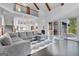 Open-concept living space with hardwood floors, vaulted ceilings, and a wall of windows at 504 Telfair Park, Peachtree City, GA 30269