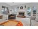 Bright living room features a stone fireplace, multiple seating options, and natural light at 504 Telfair Park, Peachtree City, GA 30269