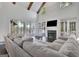 Bright living room boasting a fireplace, vaulted ceiling, exposed beams, and a view to a lakeside deck at 504 Telfair Park, Peachtree City, GA 30269
