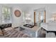 Elegant living room featuring a cozy gray couch, matching chairs, plantation shutters, and a decorative wall hanging at 504 Telfair Park, Peachtree City, GA 30269