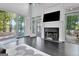 Living room with fireplace, large windows, and access to the outdoor living area at 504 Telfair Park, Peachtree City, GA 30269