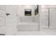 Beautiful bathroom showcasing a modern tub and shower with white marble-style tile surround at 566 Silver Moon Drive # 21, Loganville, GA 30052