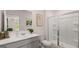 Bright bathroom featuring a glass shower, white vanity, decorative art, and neutral wall color at 566 Silver Moon Drive # 21, Loganville, GA 30052