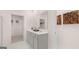 Bright bathroom featuring double sinks, and a separate storage area at 566 Silver Moon Drive # 21, Loganville, GA 30052