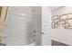 Bright bathroom with a shower-tub combo, white tile, and modern fixtures at 566 Silver Moon Drive # 21, Loganville, GA 30052