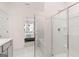 Bathroom featuring a tiled shower and bathtub combination, with a partial view of the bedroom at 566 Silver Moon Drive # 21, Loganville, GA 30052