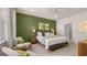 Serene bedroom with a green accent wall, stylish furnishings, and soft, natural lighting at 566 Silver Moon Drive # 21, Loganville, GA 30052