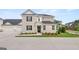 Charming two-story home with a brick exterior, black shutters, a well-manicured lawn, and an attached two car garage at 566 Silver Moon Drive # 21, Loganville, GA 30052