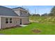 Back exterior of a brick home with a small patio and a green lawn at 566 Silver Moon Drive # 21, Loganville, GA 30052