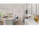 Modern kitchen with white cabinetry, stainless steel appliances, and a spacious island perfect for cooking and entertaining at 566 Silver Moon Drive # 21, Loganville, GA 30052