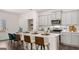 Modern kitchen design with stainless steel appliances, bar stool seating at the island, and white subway tile backsplash at 566 Silver Moon Drive # 21, Loganville, GA 30052