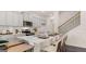 Charming kitchen with white cabinets, stainless steel appliances, and a center island with bar stool seating at 566 Silver Moon Drive # 21, Loganville, GA 30052