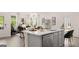 Open-concept kitchen boasts a large island with seating and seamlessly connects to the cozy living area at 566 Silver Moon Drive # 21, Loganville, GA 30052