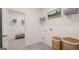 Neat laundry room with wire shelving, decor baskets, and a bench visible through the doorway at 566 Silver Moon Drive # 21, Loganville, GA 30052