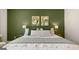 Comfortable main bedroom with green accent wall, plush bedding, and decorative wall art at 566 Silver Moon Drive # 21, Loganville, GA 30052