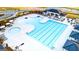 Aerial view of a large swimming pool with lounge chairs and umbrellas in a well-maintained community at 566 Silver Moon Drive # 21, Loganville, GA 30052