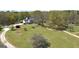 Aerial view of a two-story home with a pool, a circle driveway, and a sprawling green lawn at 935 Amelia Rd, Locust Grove, GA 30248