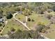 Drone shot of sprawling property featuring winding driveway, mature trees, and well-maintained lawns at 935 Amelia Rd, Locust Grove, GA 30248