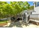 Beautiful backyard with mature trees, a large deck, a patio, and fenced pool at 935 Amelia Rd, Locust Grove, GA 30248