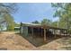 Exterior view of barn featuring drive-through, covered parking, and green siding at 935 Amelia Rd, Locust Grove, GA 30248