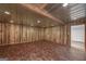 Open basement space featuring wood paneled walls and a glimpse into an adjacent room at 935 Amelia Rd, Locust Grove, GA 30248