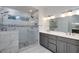 Modern bathroom featuring a double sink vanity, a glass shower, and elegant tile at 935 Amelia Rd, Locust Grove, GA 30248