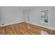 Bright bedroom featuring hardwood floors, a ceiling fan, and two large windows at 935 Amelia Rd, Locust Grove, GA 30248