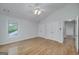 Bedroom featuring hardwood floors, white walls, a ceiling fan and a window for natural light at 935 Amelia Rd, Locust Grove, GA 30248