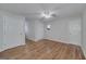 Bedroom featuring hardwood floors, white walls, ceiling fan, and natural light from a window at 935 Amelia Rd, Locust Grove, GA 30248