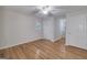 Bedroom featuring hardwood floors, white walls, and natural light from the window at 935 Amelia Rd, Locust Grove, GA 30248