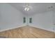 Bright bedroom with hardwood floors, a ceiling fan, and two windows offering natural light at 935 Amelia Rd, Locust Grove, GA 30248